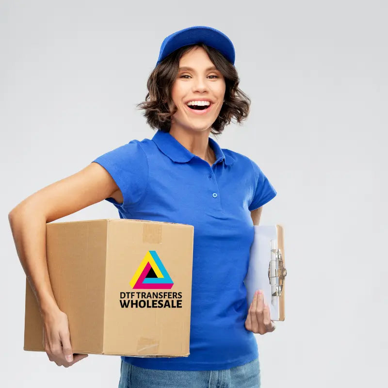 Print shop owner applying wholesale DTF transfer to apparel with commercial heat press